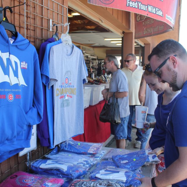 Couple browsing sports t-shirts at flea market in Shipshewana Indiana